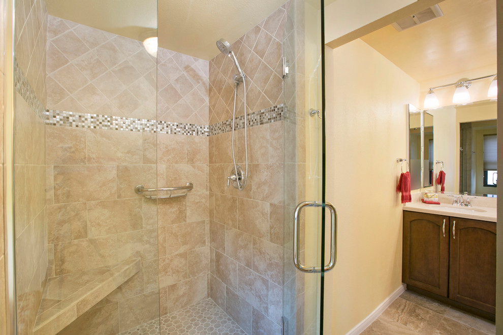 Alcove shower - large traditional master beige tile and porcelain tile porcelain tile alcove shower idea in San Diego with recessed-panel cabinets, dark wood cabinets, a two-piece toilet, beige walls, an undermount sink and quartz countertops