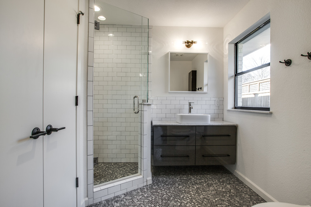 Photo of a medium sized modern family bathroom in Dallas with flat-panel cabinets, grey cabinets, a corner shower, white tiles, metro tiles, white walls, mosaic tile flooring, a vessel sink, marble worktops, grey floors and a hinged door.