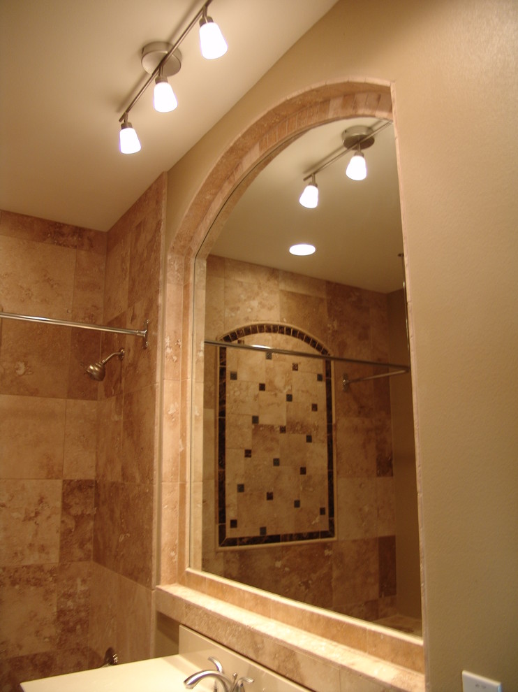 Design ideas for a mediterranean bathroom in Austin with a shower/bath combination, stone tiles and beige walls.