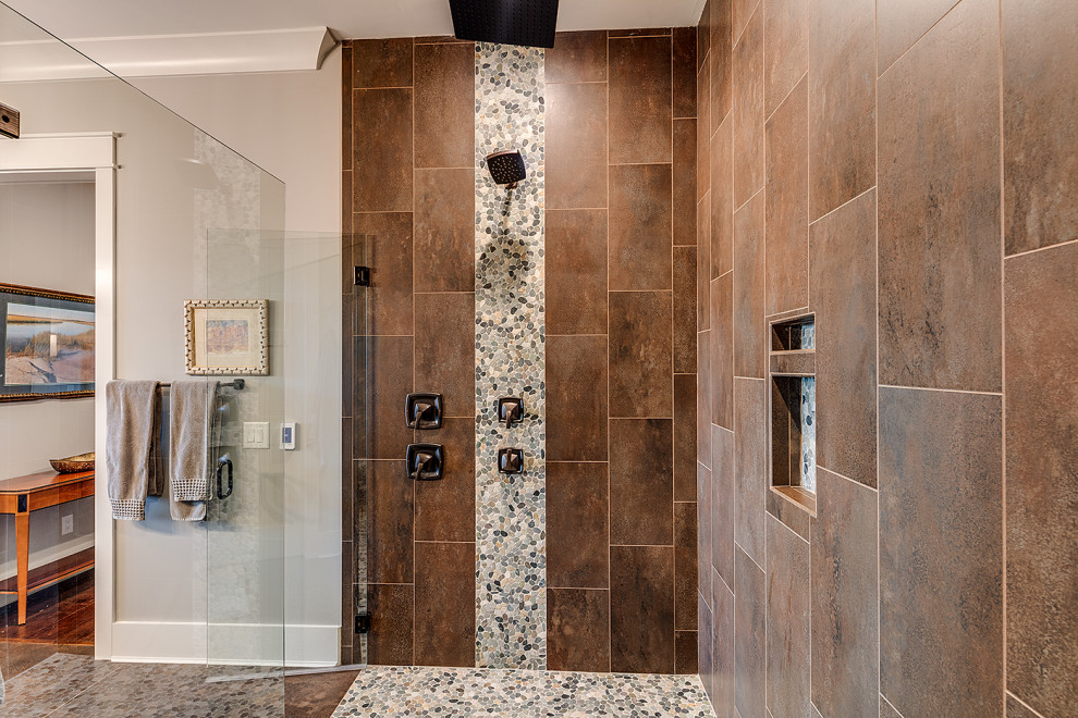Alcove shower - mid-sized rustic master brown tile brown floor alcove shower idea in Other with recessed-panel cabinets, beige cabinets, a one-piece toilet, gray walls, an undermount sink, a hinged shower door and multicolored countertops