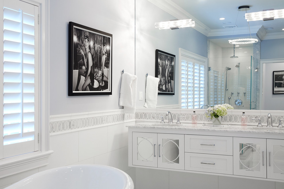 Example of a large transitional master white tile and glass tile marble floor bathroom design in New York with furniture-like cabinets, white cabinets, a wall-mount toilet, blue walls, an undermount sink and marble countertops