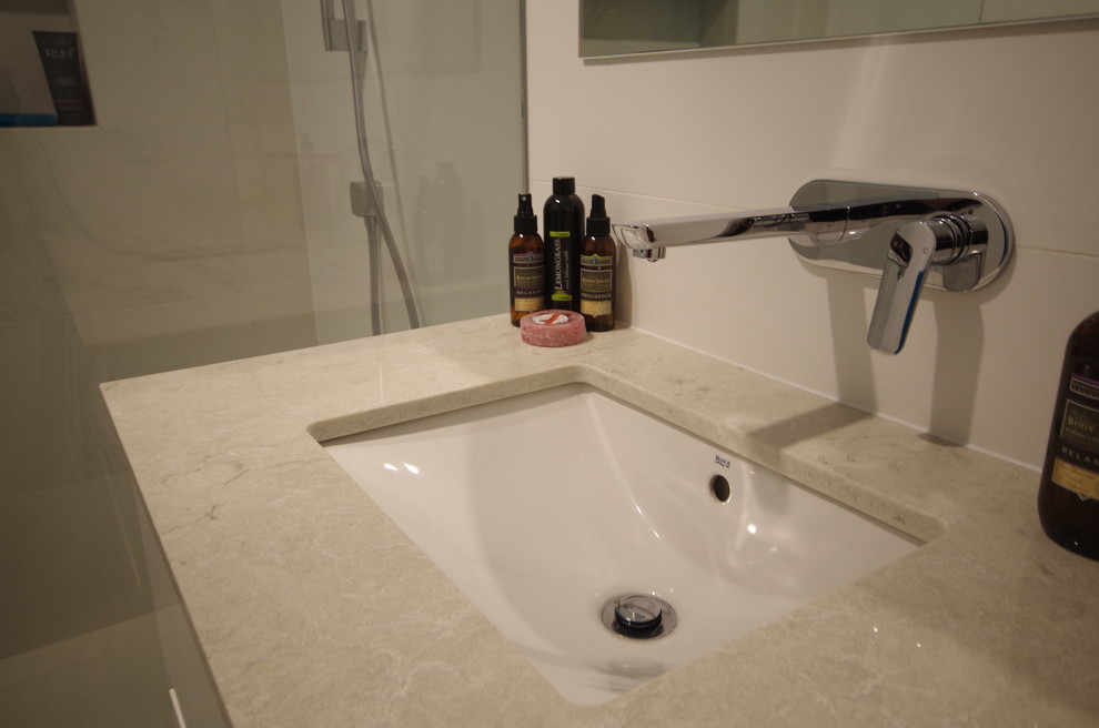 Example of a trendy master white tile and porcelain tile porcelain tile and yellow floor bathroom design in Perth with furniture-like cabinets, white cabinets, white walls, an undermount sink, quartz countertops and white countertops