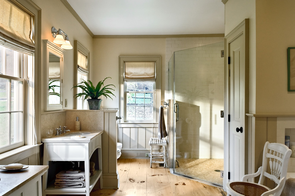 This is an example of a traditional bathroom in New York with a corner shower.