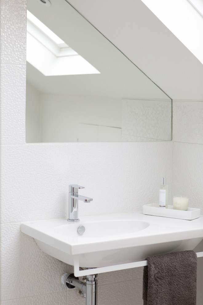 This is an example of a small contemporary ensuite bathroom in Kent with white tiles, ceramic tiles, a wall-mounted sink and white walls.