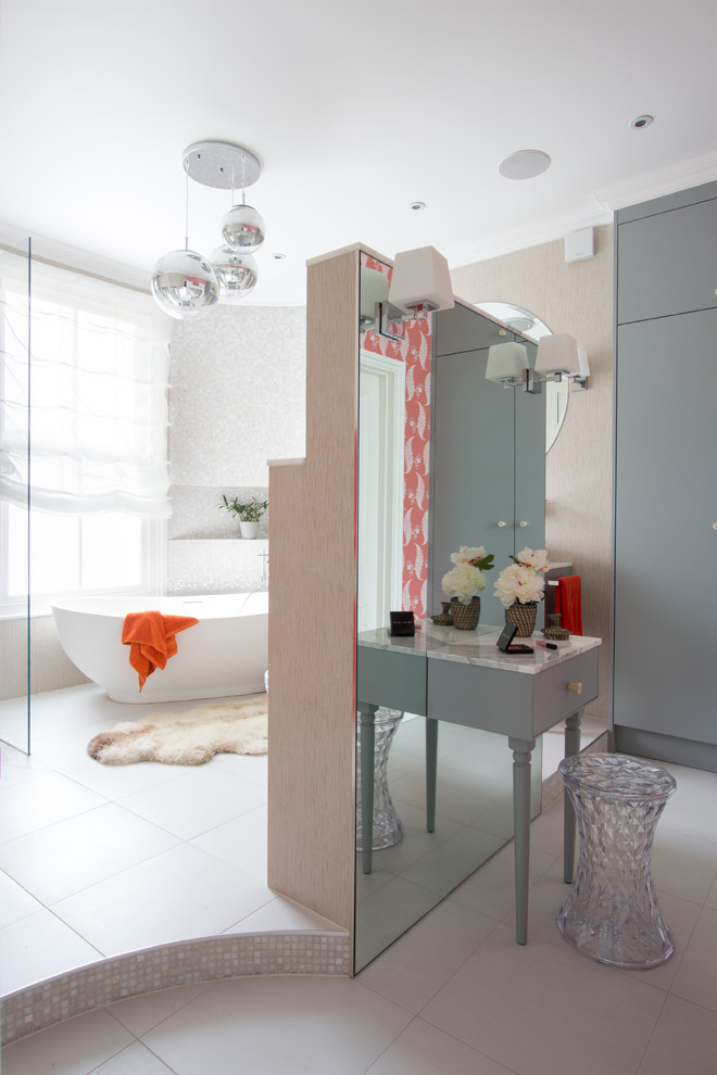 Large contemporary ensuite bathroom in London with freestanding cabinets, a freestanding bath and feature lighting.