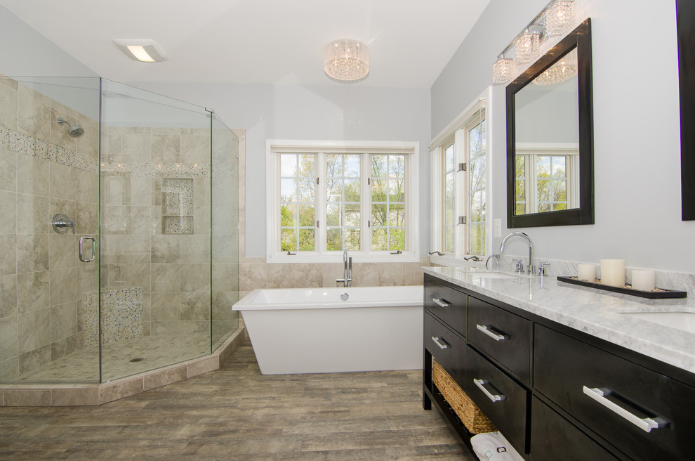 Medium sized classic ensuite bathroom in DC Metro with a submerged sink, shaker cabinets, dark wood cabinets, granite worktops, a freestanding bath, a corner shower, a two-piece toilet, beige tiles, ceramic tiles, blue walls, porcelain flooring, brown floors and a hinged door.