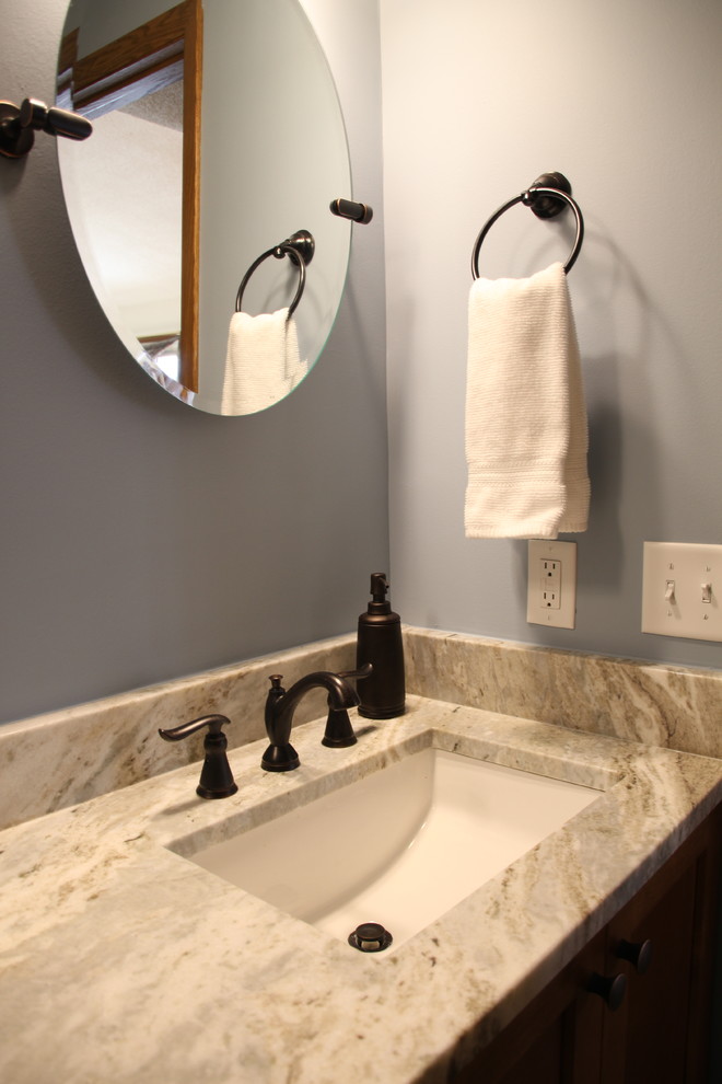 This is an example of a medium sized contemporary family bathroom in Minneapolis with dark wood cabinets, an alcove bath, a shower/bath combination, blue walls, ceramic flooring, a submerged sink, granite worktops, a shower curtain, white worktops and recessed-panel cabinets.