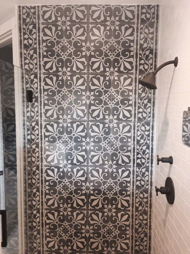 Tuscan black tile and cement tile doorless shower photo in Miami