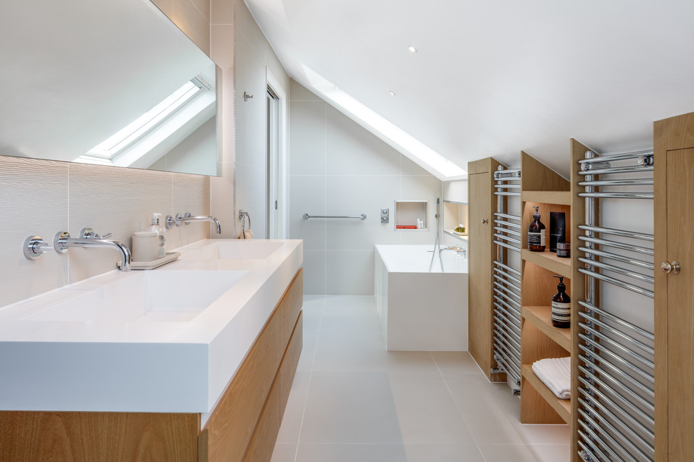 This is an example of a large contemporary ensuite bathroom in London with flat-panel cabinets, brown cabinets, a walk-in shower, a wall mounted toilet, beige tiles, porcelain tiles, beige walls, porcelain flooring, a wall-mounted sink, beige floors and an open shower.
