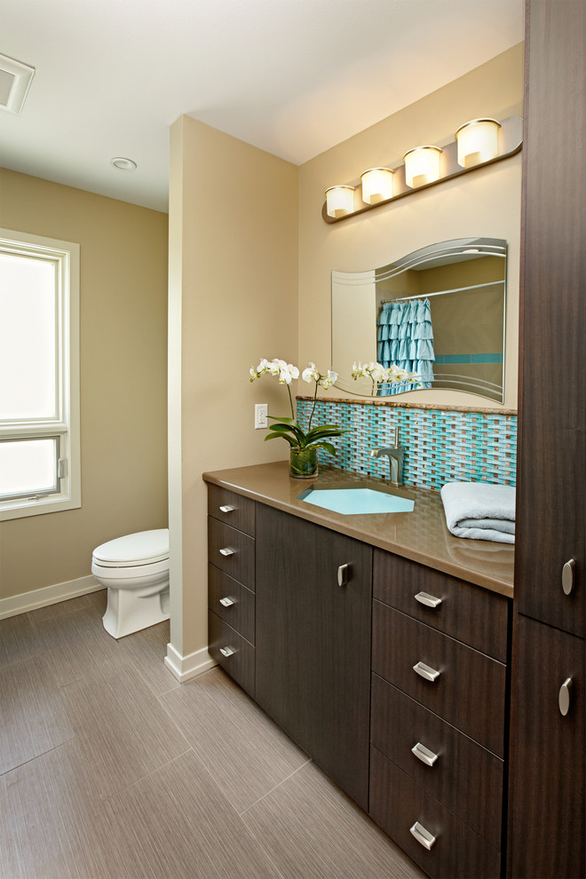 Example of a small trendy kids' blue tile and glass tile ceramic tile bathroom design in Milwaukee with an undermount sink, flat-panel cabinets, dark wood cabinets, quartz countertops, a two-piece toilet and beige walls