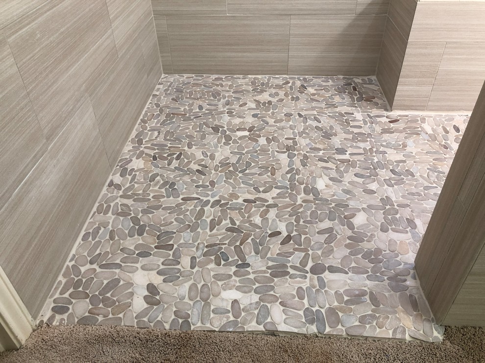 Large modern ensuite bathroom in Austin with a built-in shower, grey tiles, ceramic tiles, pebble tile flooring and a submerged sink.