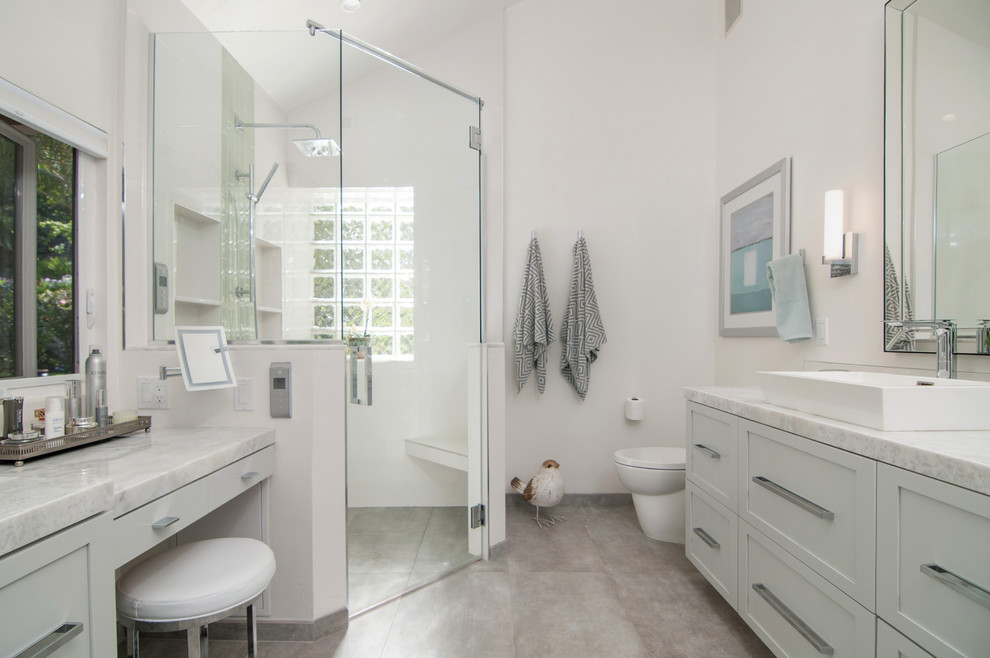 Photo of a large classic ensuite bathroom in San Diego with shaker cabinets, grey cabinets, a corner shower, a one-piece toilet, white tiles, porcelain tiles, white walls, porcelain flooring, a vessel sink, marble worktops, grey floors, a hinged door and a freestanding bath.