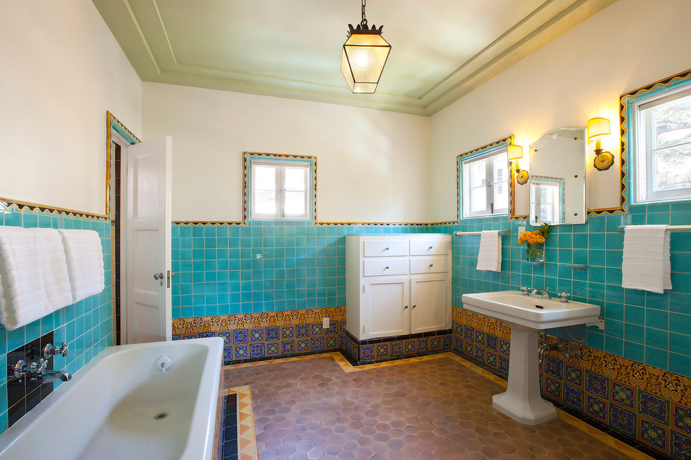 This is an example of a mediterranean half tiled bathroom in Los Angeles with a pedestal sink.