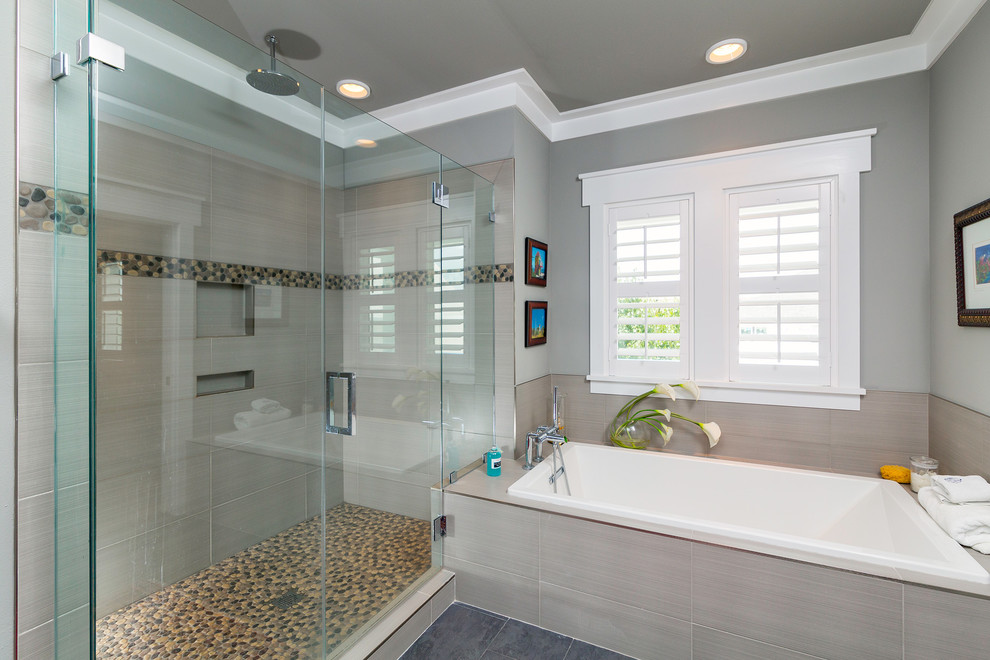 Photo of a medium sized nautical ensuite bathroom in Atlanta with a submerged sink, shaker cabinets, white cabinets, solid surface worktops, an alcove shower, a one-piece toilet, white tiles, porcelain tiles, white walls and porcelain flooring.