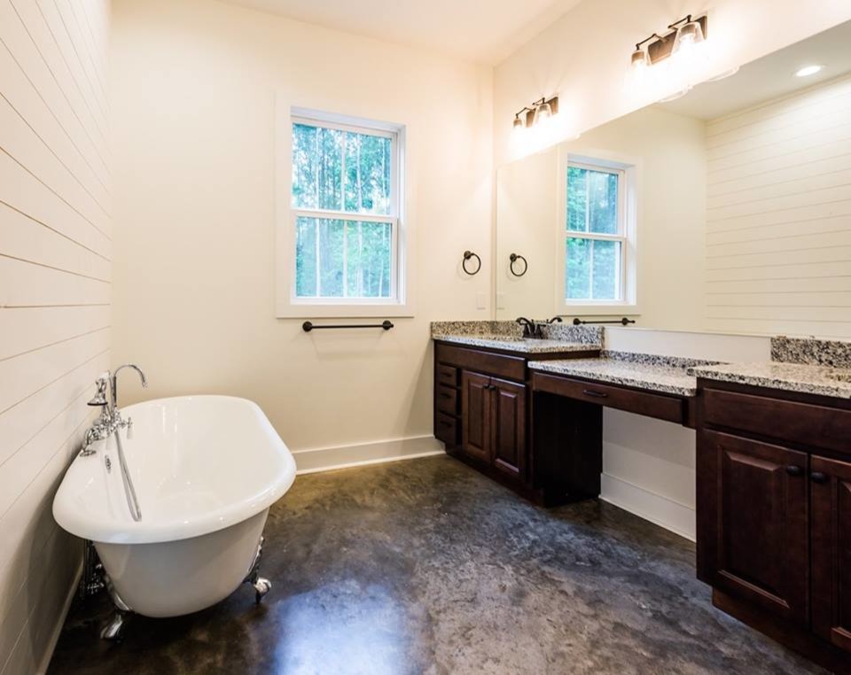 Large cottage master white tile concrete floor and gray floor bathroom photo in Atlanta with raised-panel cabinets, dark wood cabinets, white walls, an undermount sink and granite countertops