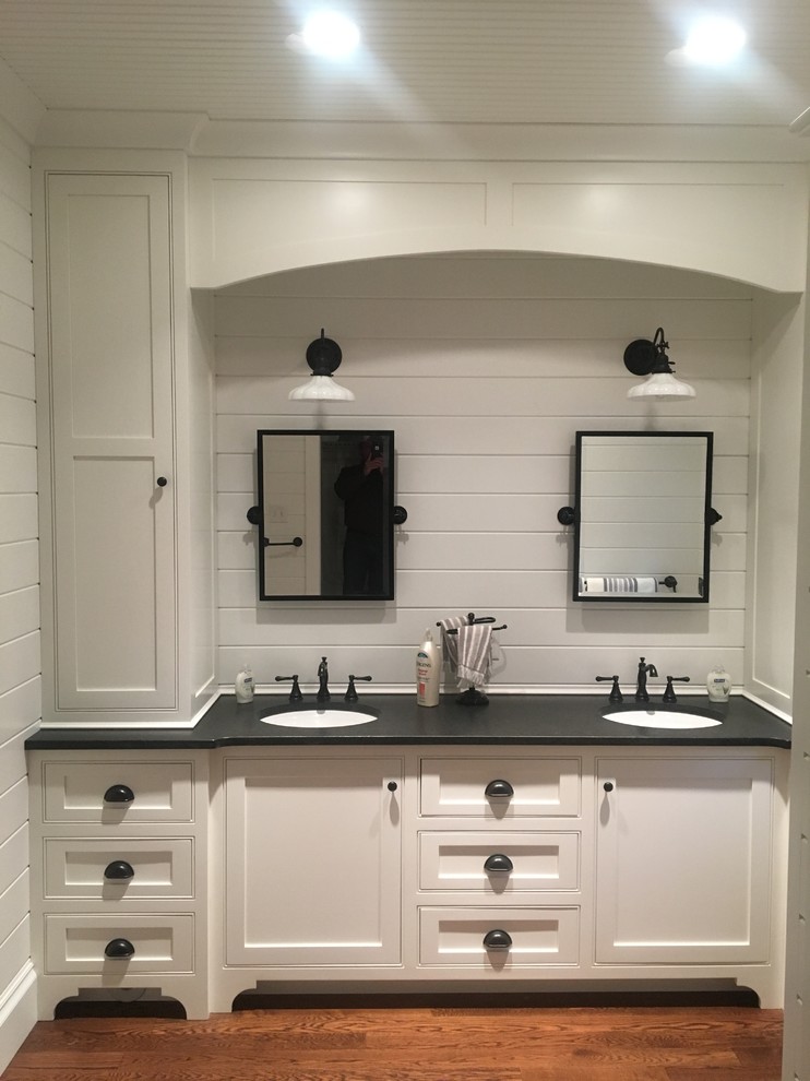 Bathroom - mid-sized traditional kids' medium tone wood floor bathroom idea in Boston with beaded inset cabinets, white cabinets, white walls, an undermount sink and soapstone countertops