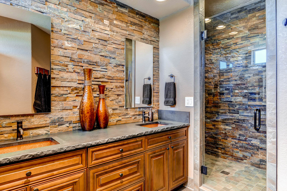 Inspiration for a huge mediterranean master brown tile and stone tile ceramic tile and multicolored floor alcove shower remodel in Denver with raised-panel cabinets, medium tone wood cabinets, a two-piece toilet, gray walls, an undermount sink, quartz countertops, a hinged shower door and gray countertops