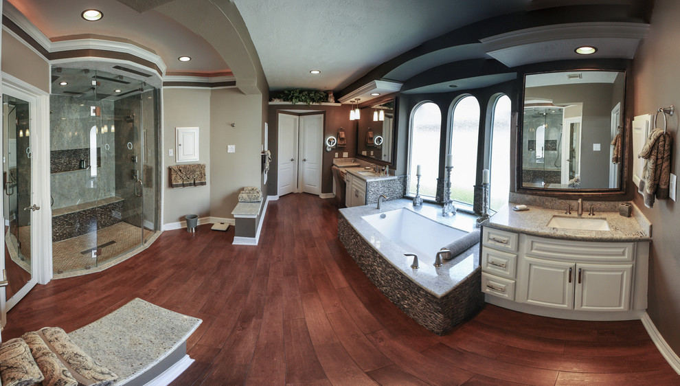 Bathroom - large transitional master stone slab dark wood floor and brown floor bathroom idea in Houston with raised-panel cabinets, white cabinets, brown walls, an undermount sink, granite countertops and a hinged shower door