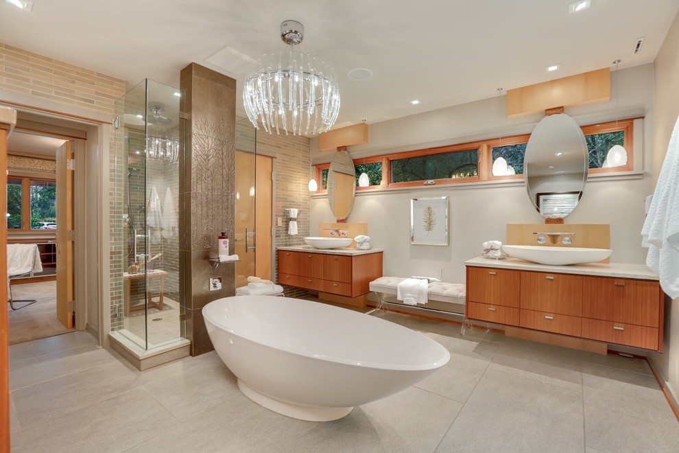 Modernes Badezimmer En Suite mit flächenbündigen Schrankfronten, hellbraunen Holzschränken, freistehender Badewanne, beigen Fliesen, Aufsatzwaschbecken, Falttür-Duschabtrennung, beiger Waschtischplatte, grauem Boden und grauer Wandfarbe in Seattle