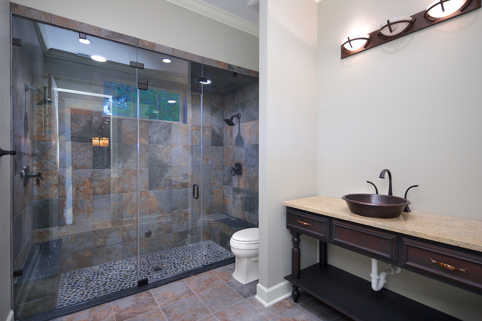 Mid-sized arts and crafts 3/4 multicolored tile and slate tile slate floor and multicolored floor double shower photo in Jacksonville with recessed-panel cabinets, dark wood cabinets, gray walls, a vessel sink, granite countertops, a hinged shower door and brown countertops