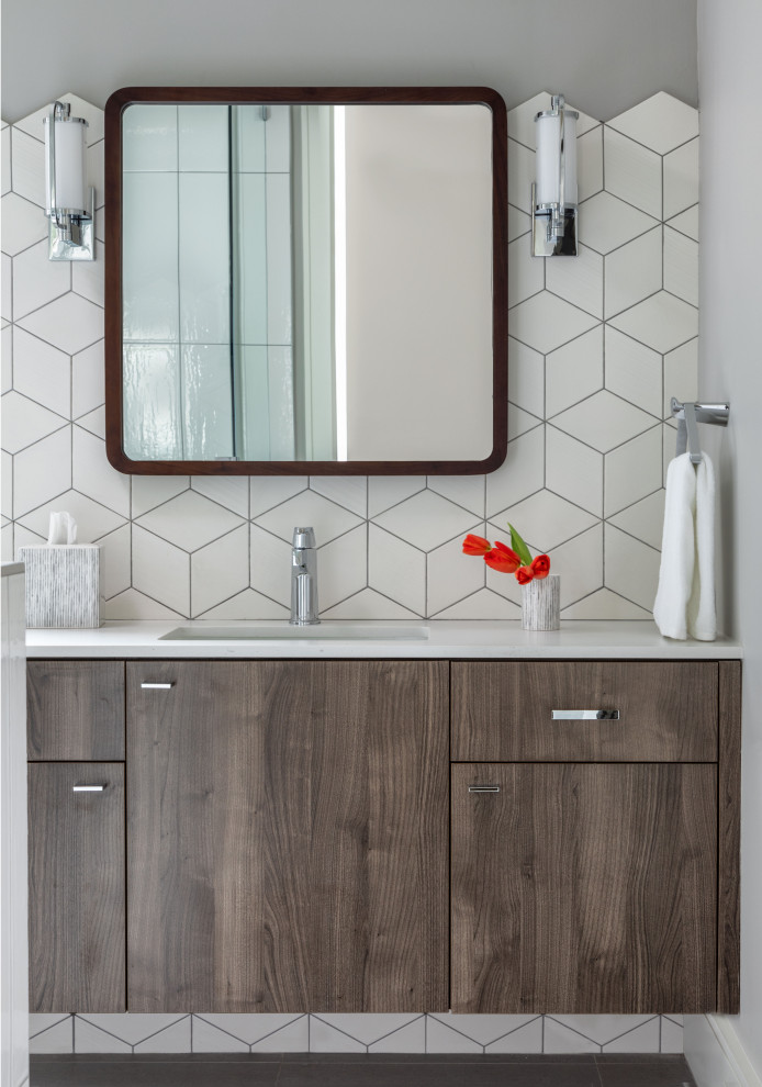 Photo of an expansive contemporary bathroom in Houston with flat-panel cabinets, dark wood cabinets, white tiles, ceramic tiles, grey walls, a submerged sink, grey floors and white worktops.