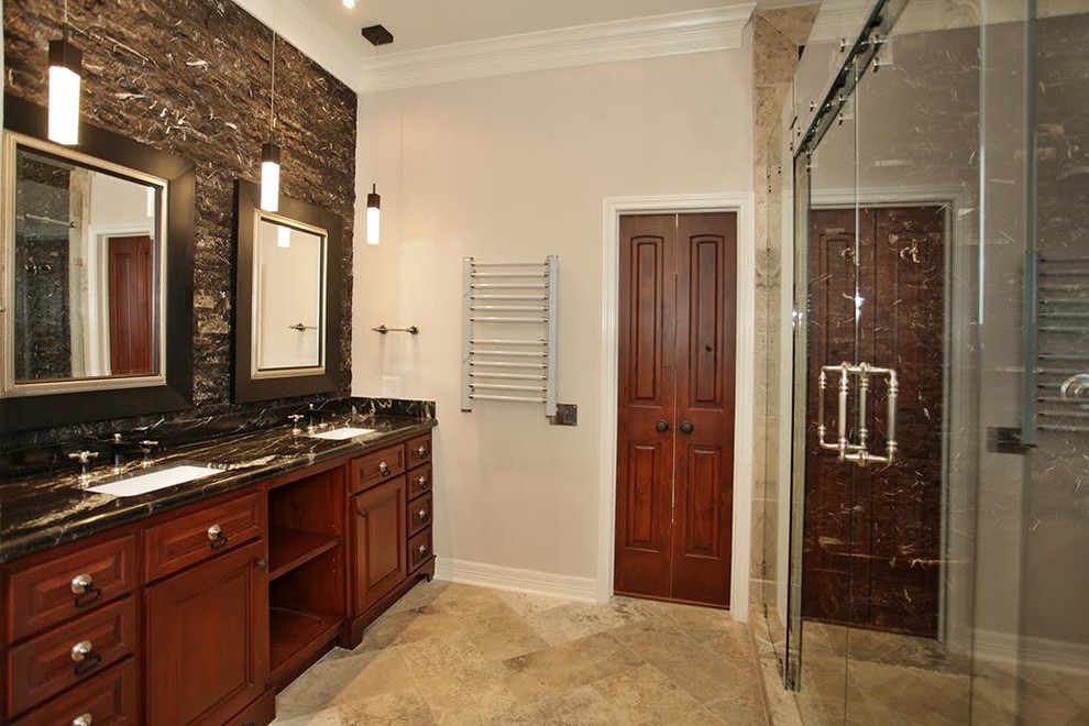 Medium sized contemporary ensuite bathroom in Houston with raised-panel cabinets, dark wood cabinets, an alcove shower, beige walls, ceramic flooring, a submerged sink, marble worktops, brown floors and a hinged door.