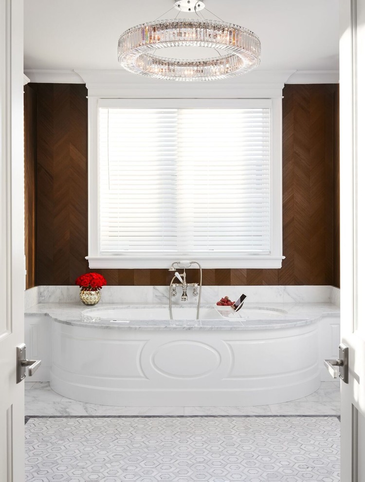 This is an example of an expansive classic ensuite bathroom in Chicago with freestanding cabinets, white cabinets, a submerged bath, white walls, marble flooring and marble worktops.