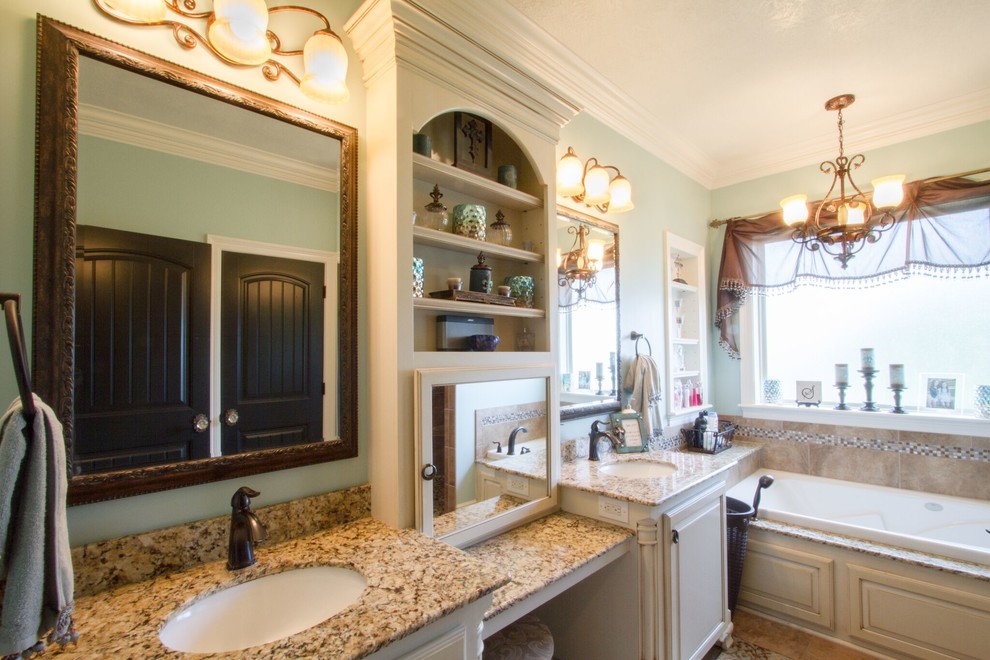 This is an example of a large traditional ensuite bathroom in New Orleans with shaker cabinets, white cabinets, an alcove bath, an alcove shower, a two-piece toilet, beige tiles, travertine tiles, blue walls, travertine flooring, a submerged sink, granite worktops, brown floors and a hinged door.