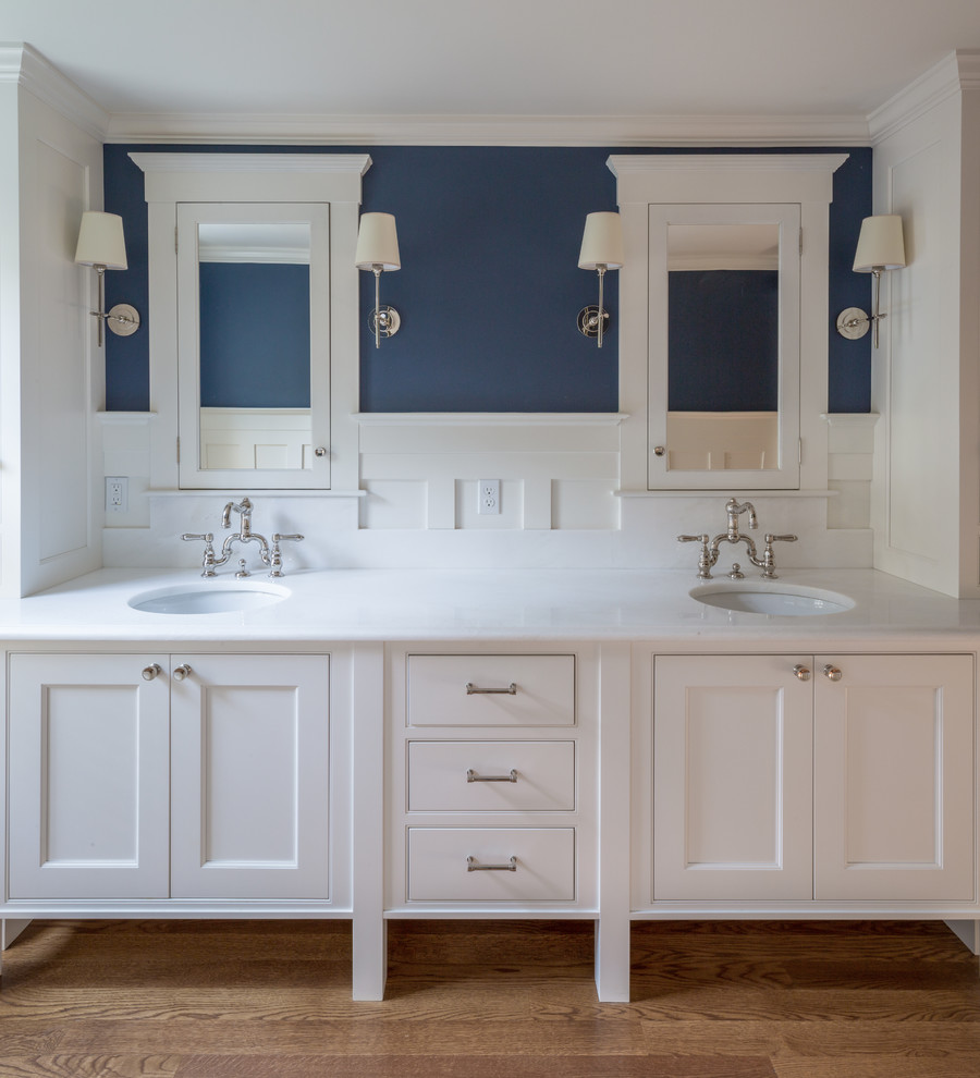 Inspiration for a classic ensuite bathroom in Boston with beaded cabinets, white cabinets, an alcove shower, a two-piece toilet, blue walls, medium hardwood flooring, a submerged sink and marble worktops.