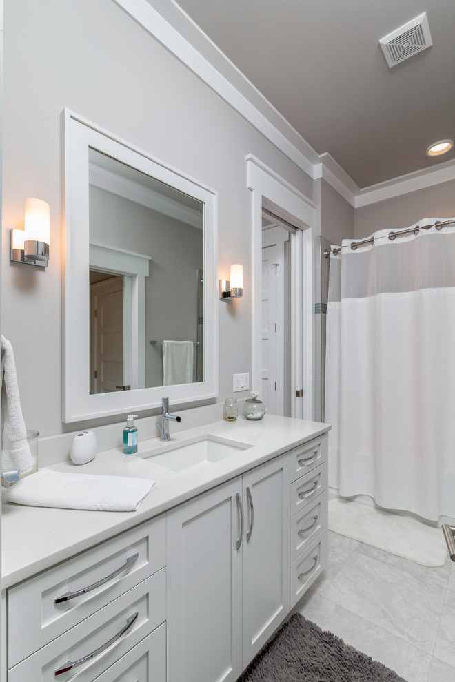 Inspiration for a mid-sized coastal kids' gray tile marble floor bathroom remodel in Other with an undermount sink, recessed-panel cabinets, white cabinets and gray walls