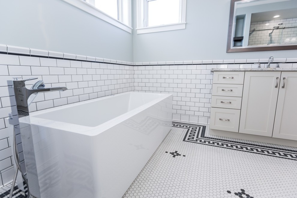 Inspiration for an expansive classic ensuite bathroom in Edmonton with shaker cabinets, beige cabinets, a freestanding bath, an alcove shower, white tiles, ceramic tiles, blue walls, mosaic tile flooring, a submerged sink and granite worktops.
