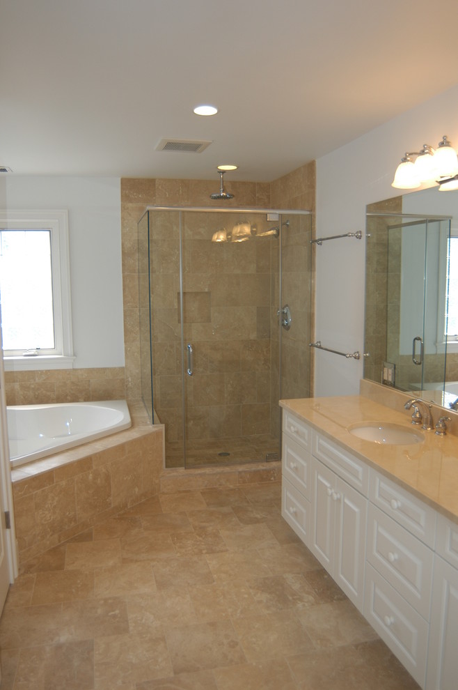 Идея дизайна: главная ванная комната в стиле неоклассика (современная классика) с врезной раковиной, белыми фасадами, гидромассажной ванной, угловым душем, бежевой плиткой, белыми стенами и полом из керамической плитки