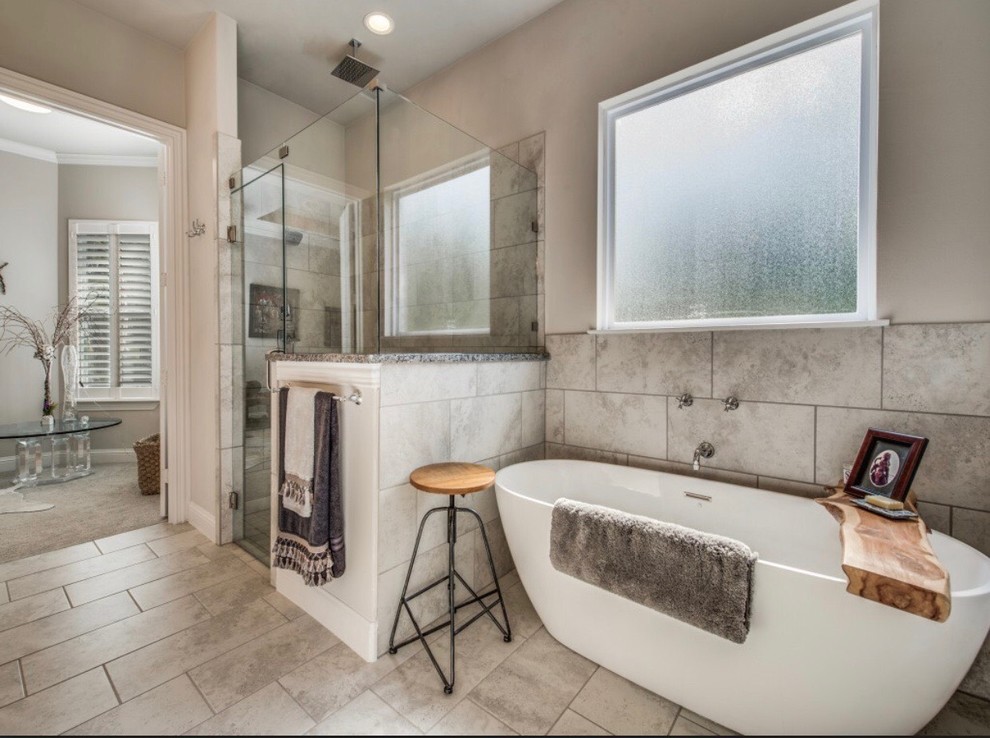 Photo of a large traditional ensuite bathroom in Dallas with shaker cabinets, grey cabinets, a freestanding bath, a walk-in shower, a one-piece toilet, grey tiles, grey walls, porcelain flooring, a built-in sink, grey floors, an open shower and multi-coloured worktops.