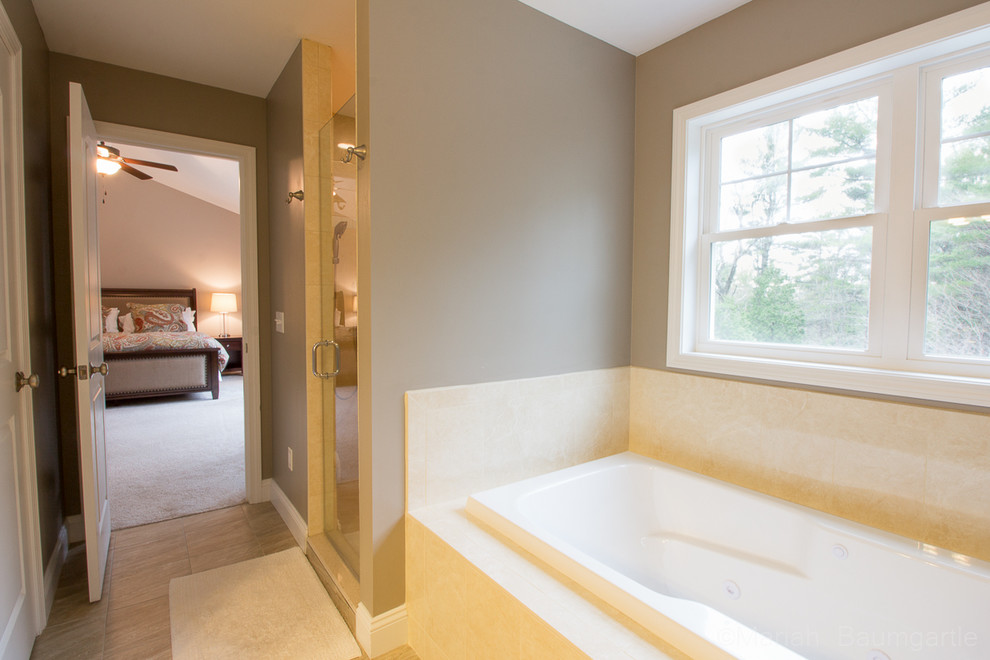 Inspiration for a classic ensuite bathroom in Burlington with a submerged sink, recessed-panel cabinets, dark wood cabinets, granite worktops, an alcove bath, an alcove shower, beige tiles, ceramic tiles, white walls and light hardwood flooring.