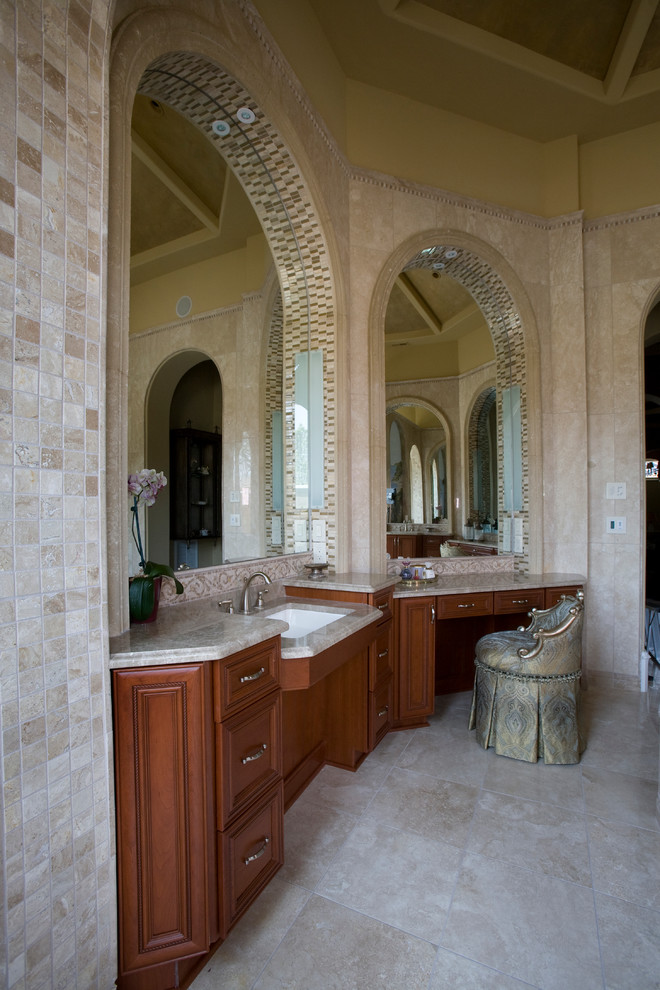 Inspiration for an expansive mediterranean ensuite bathroom in Raleigh with recessed-panel cabinets, medium wood cabinets, a built-in bath, a built-in shower, beige walls, travertine flooring, a submerged sink, granite worktops, beige floors, an open shower, beige tiles and travertine tiles.