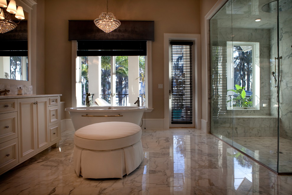 Huge elegant white tile marble floor bathroom photo in Orlando with an integrated sink, raised-panel cabinets, white cabinets, marble countertops and gray walls