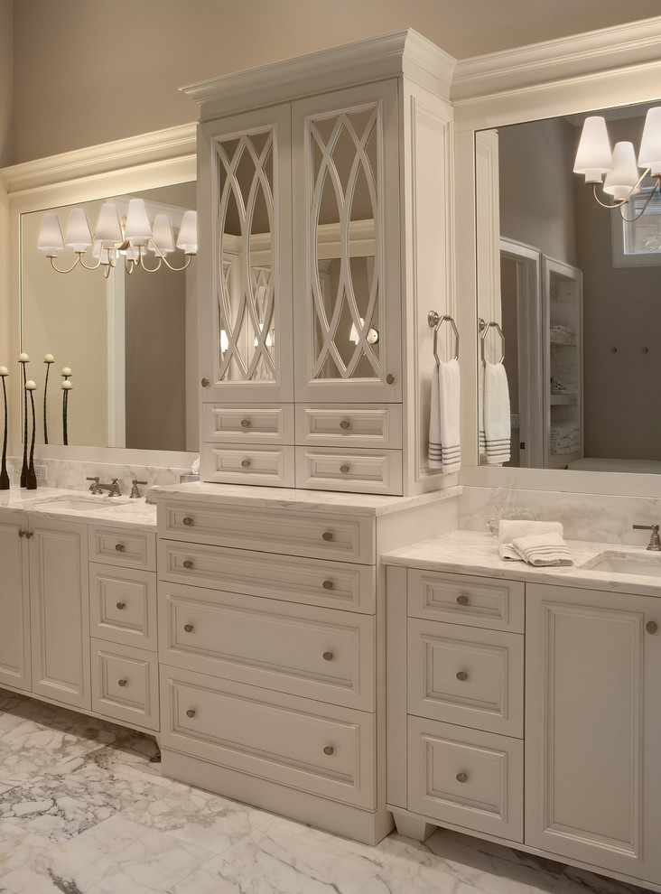 Inspiration for a huge timeless white tile marble floor freestanding bathtub remodel in Orlando with an integrated sink, white cabinets, marble countertops, gray walls and recessed-panel cabinets