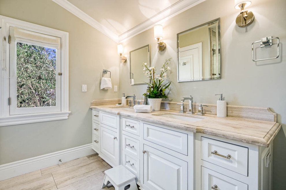 Example of a mid-sized classic kids' porcelain tile and beige floor bathroom design in Los Angeles with raised-panel cabinets, white cabinets, beige walls, granite countertops and beige countertops