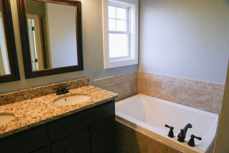 This is an example of a contemporary ensuite bathroom in Atlanta with granite worktops, beige tiles and ceramic tiles.