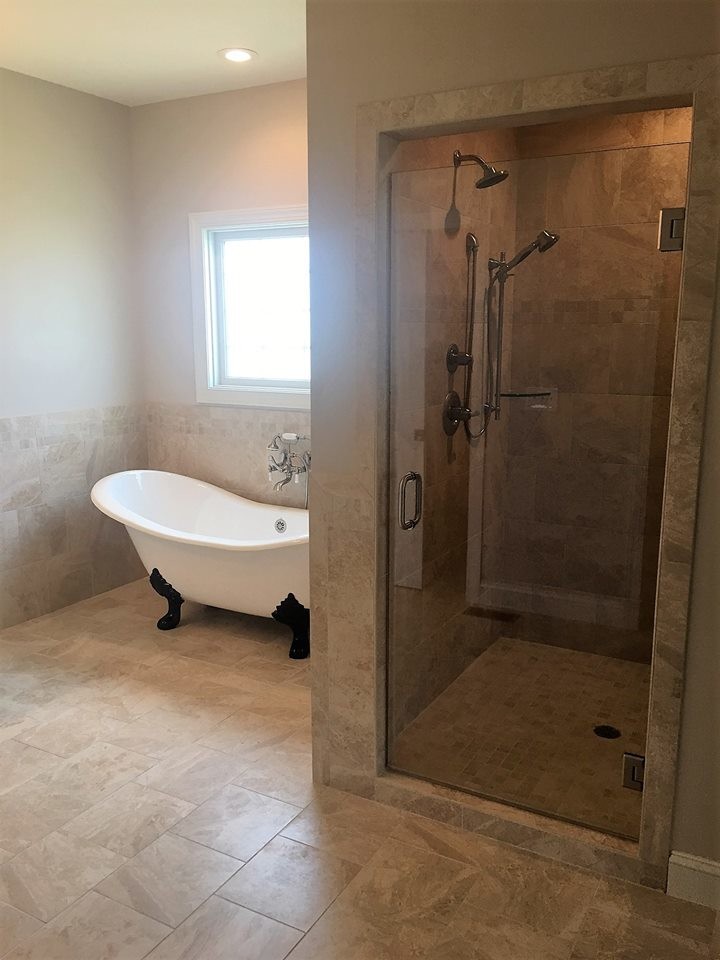 This is an example of a classic ensuite bathroom in Huntington with raised-panel cabinets, a claw-foot bath, an alcove shower, beige walls, a submerged sink, granite worktops, beige floors, a hinged door and grey cabinets.