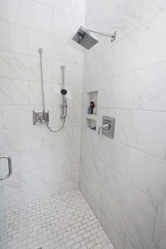 Inspiration for a large traditional ensuite bathroom in Charlotte with an alcove shower, white tiles, stone tiles, grey walls, marble flooring, recessed-panel cabinets, white cabinets and a freestanding bath.