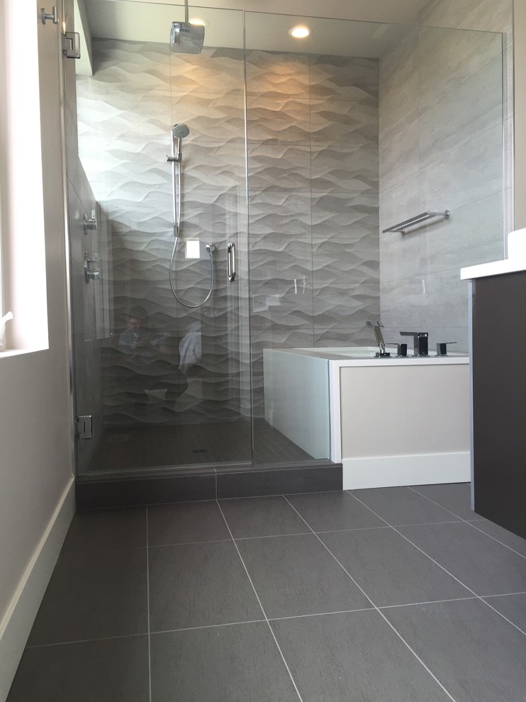 Inspiration for a small contemporary master beige tile and ceramic tile porcelain tile and gray floor alcove shower remodel in Seattle with flat-panel cabinets, dark wood cabinets, an undermount tub, gray walls, a vessel sink, quartzite countertops and a hinged shower door