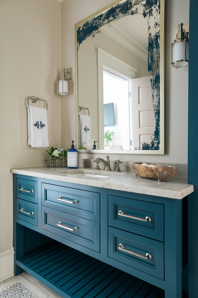 Beach style bathroom photo in Atlanta with recessed-panel cabinets, blue cabinets, beige walls, an undermount sink, granite countertops and beige countertops