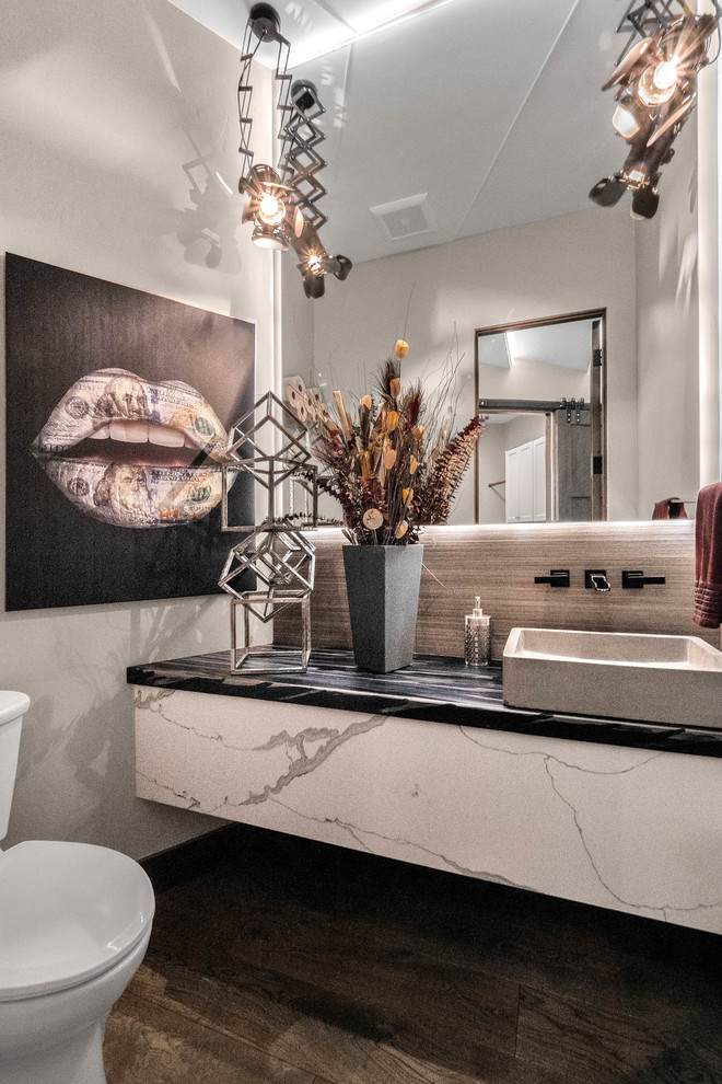 Exemple d'une petite salle de bain moderne avec un carrelage gris et un plan de toilette en acier inoxydable.