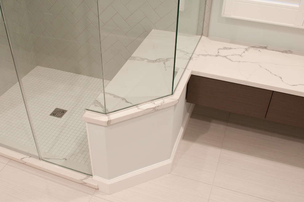 Design ideas for a medium sized contemporary ensuite bathroom in Baltimore with freestanding cabinets, grey cabinets, a two-piece toilet, grey tiles, porcelain tiles, blue walls, porcelain flooring, a submerged sink, engineered stone worktops, white floors and a hinged door.