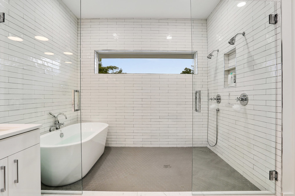 Стильный дизайн: большая главная ванная комната в стиле модернизм с плоскими фасадами, белыми фасадами, отдельно стоящей ванной, открытым душем, инсталляцией, белой плиткой, плиткой кабанчик, белыми стенами, полом из мозаичной плитки, врезной раковиной, столешницей из гранита, серым полом и открытым душем - последний тренд