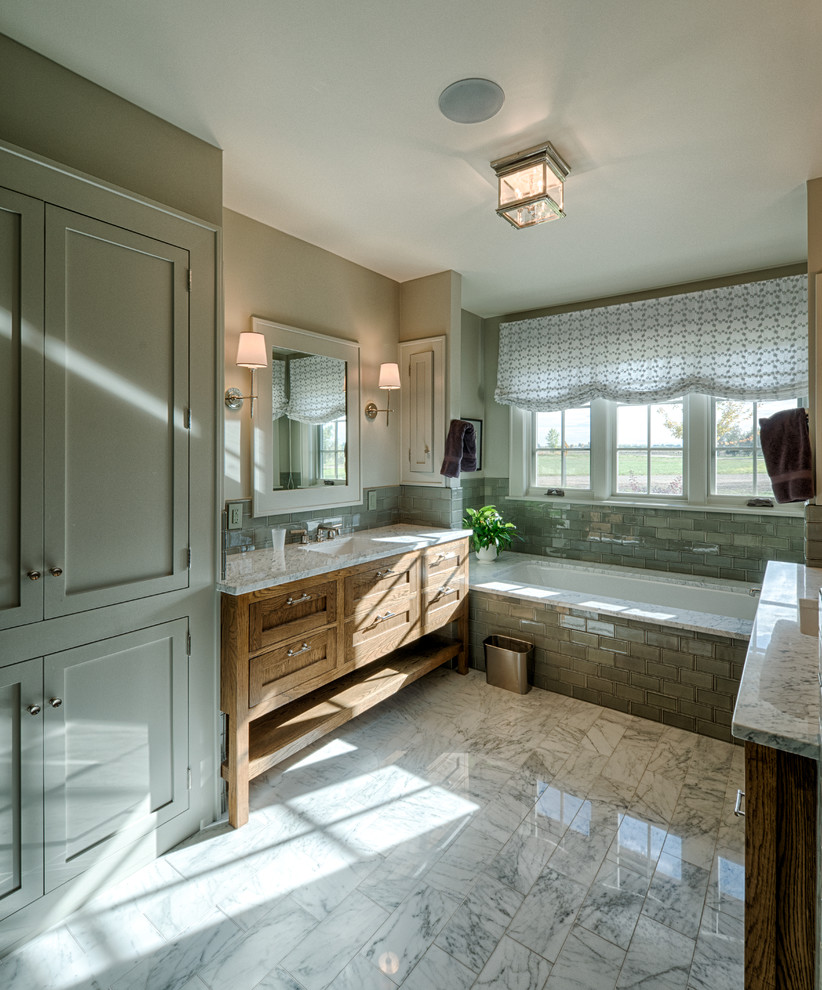 Design ideas for a medium sized farmhouse ensuite bathroom in Denver with a built-in sink, shaker cabinets, granite worktops, a built-in bath, a two-piece toilet, green tiles, glass tiles, beige walls and medium wood cabinets.