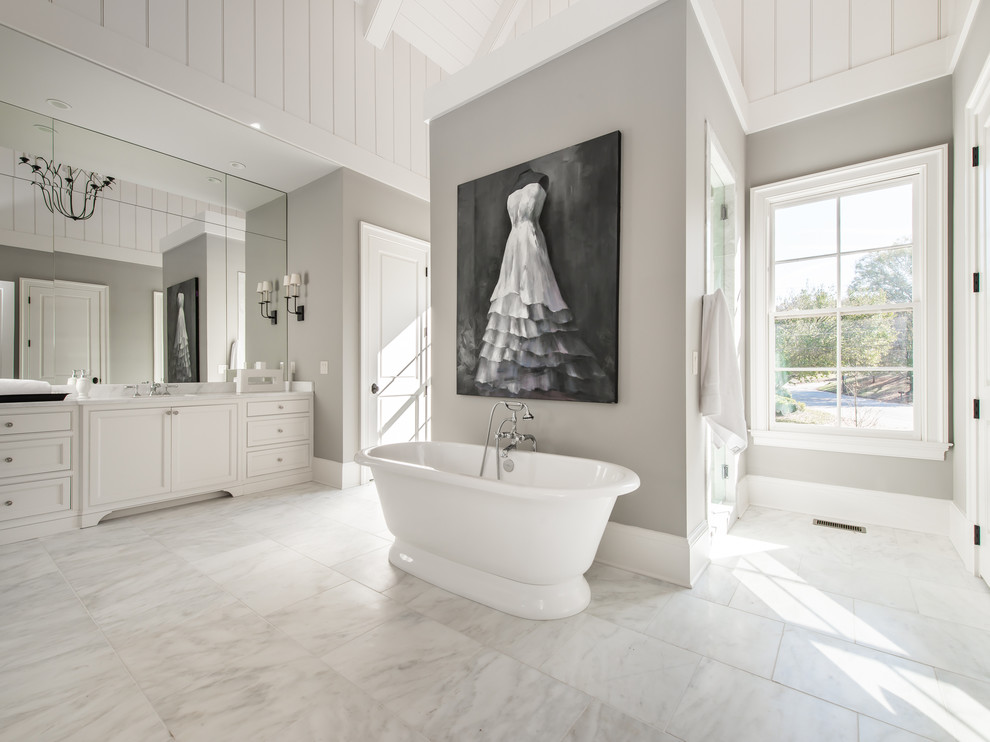 Inredning av ett klassiskt en-suite badrum, med skåp i shakerstil, vita skåp, ett fristående badkar och vita väggar