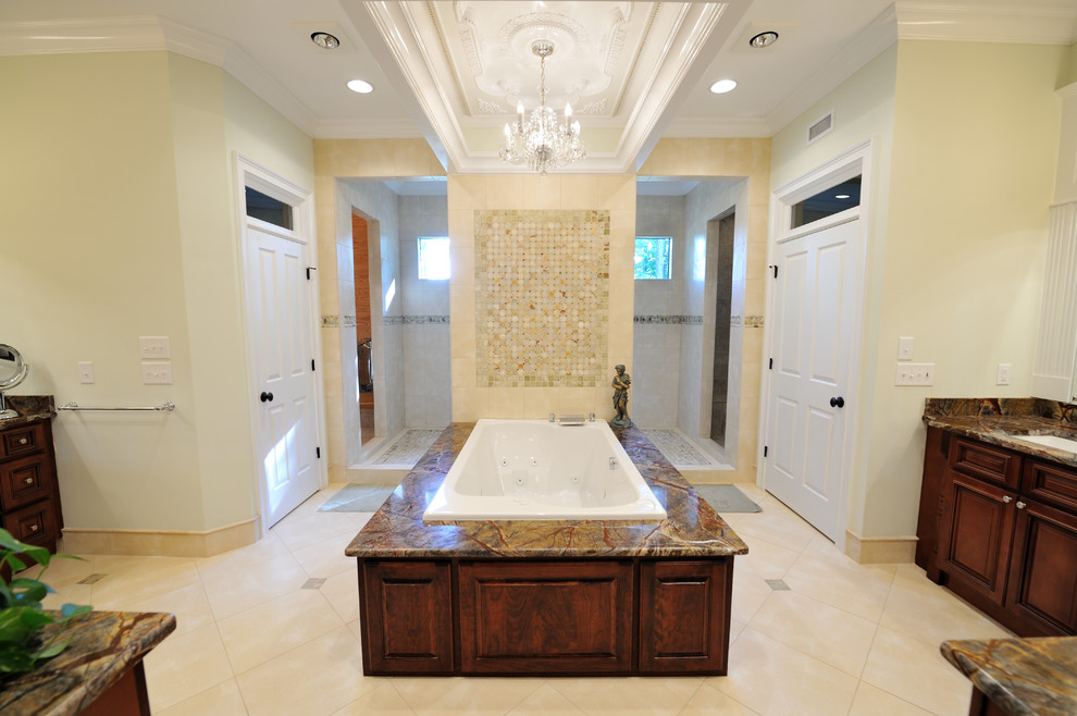 Inspiration for an ensuite bathroom in Raleigh with marble worktops, beige tiles, medium wood cabinets, a freestanding bath, a double shower, beige walls and travertine flooring.