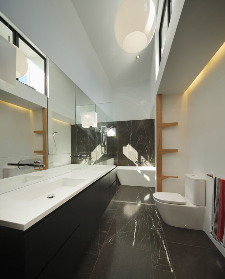 Example of a large trendy master black tile and marble tile marble floor bathroom design in Brisbane with a one-piece toilet, white walls, a drop-in sink and marble countertops